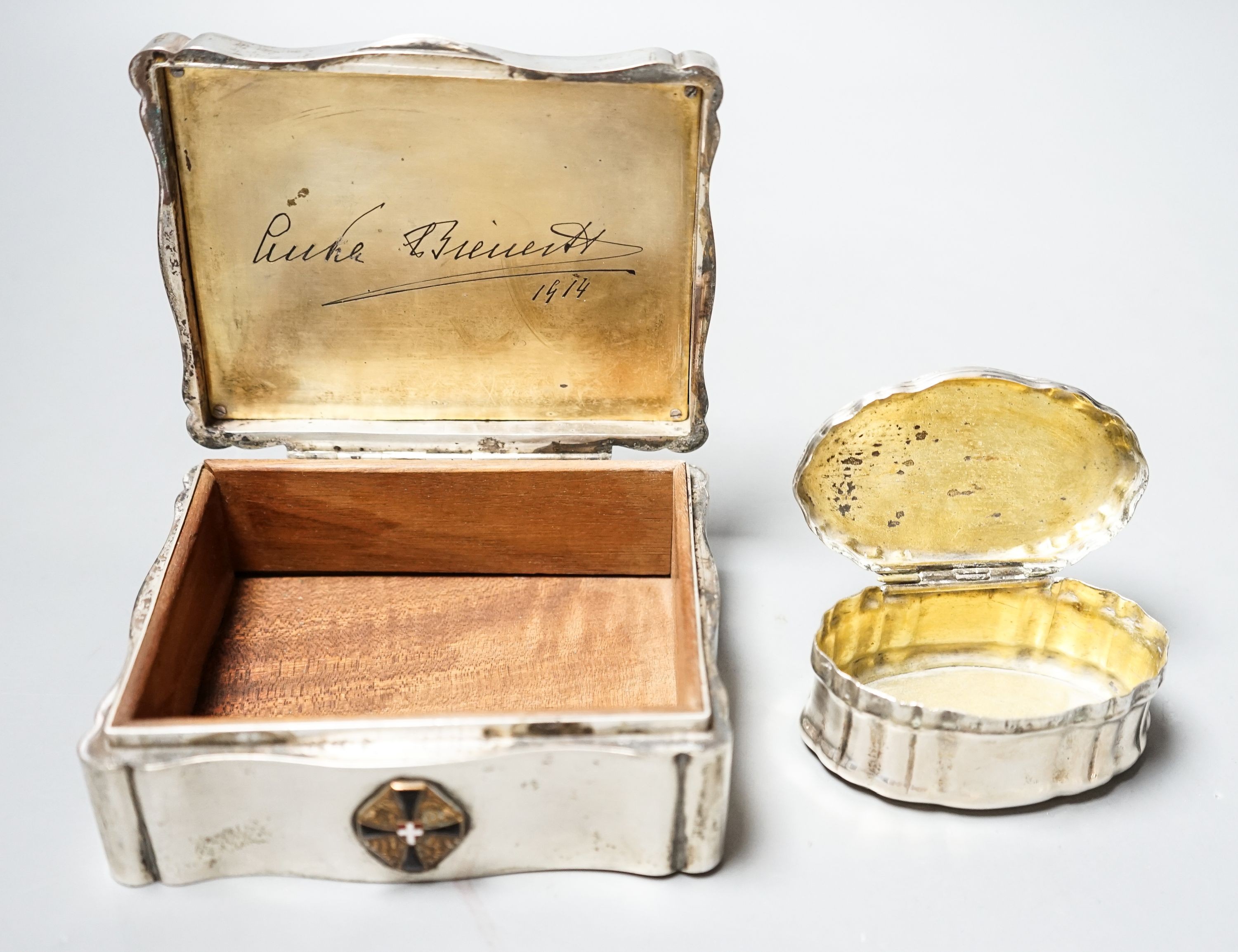 An Austro-Hungarian white metal mounted cigarette box with lid inset with print of a townscape, 12.3cm and a continental white metal oval snuff box.